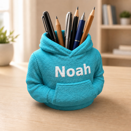 Türkisfarbener personalisierter Hoodie-Stiftehalter mit weißem Namen Noah und Stiften auf hellem Schreibtisch