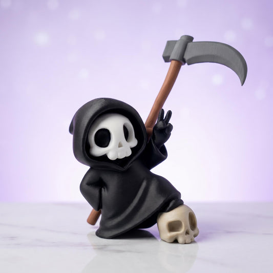 Sensenmann-Figur steht mit einem Fuß auf einem Totenkopf und zeigt das Peace-Zeichen – 3D-gedruckte Gothic-Mini-Deko