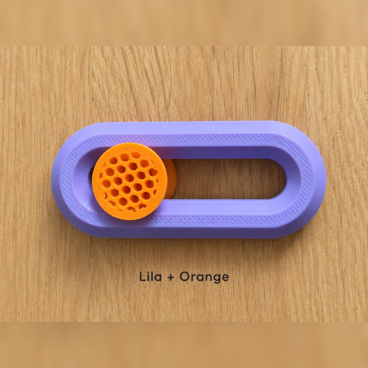 Lila Fidget Slider mit orangefarbenem Knubbel.