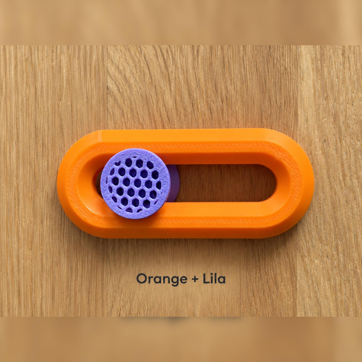 Orangefarbener Fidget Slider mit lilafarbenem Knubbel.