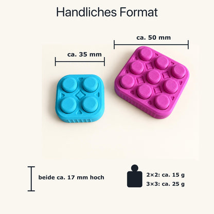 Maß- und Gewichtsgrafik für den Bubble Popper: 2×2 etwa 35 Millimeter und 15 Gramm, 3×3 etwa 50 Millimeter und 25 Gramm, beide etwa 17 Millimeter hoch.