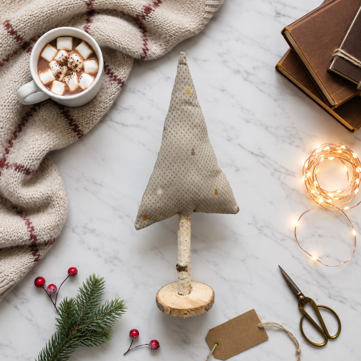 Stoff-Tannenbaum in Weiß und Gold als helle, natürliche Tischdeko zur Weihnachtszeit.