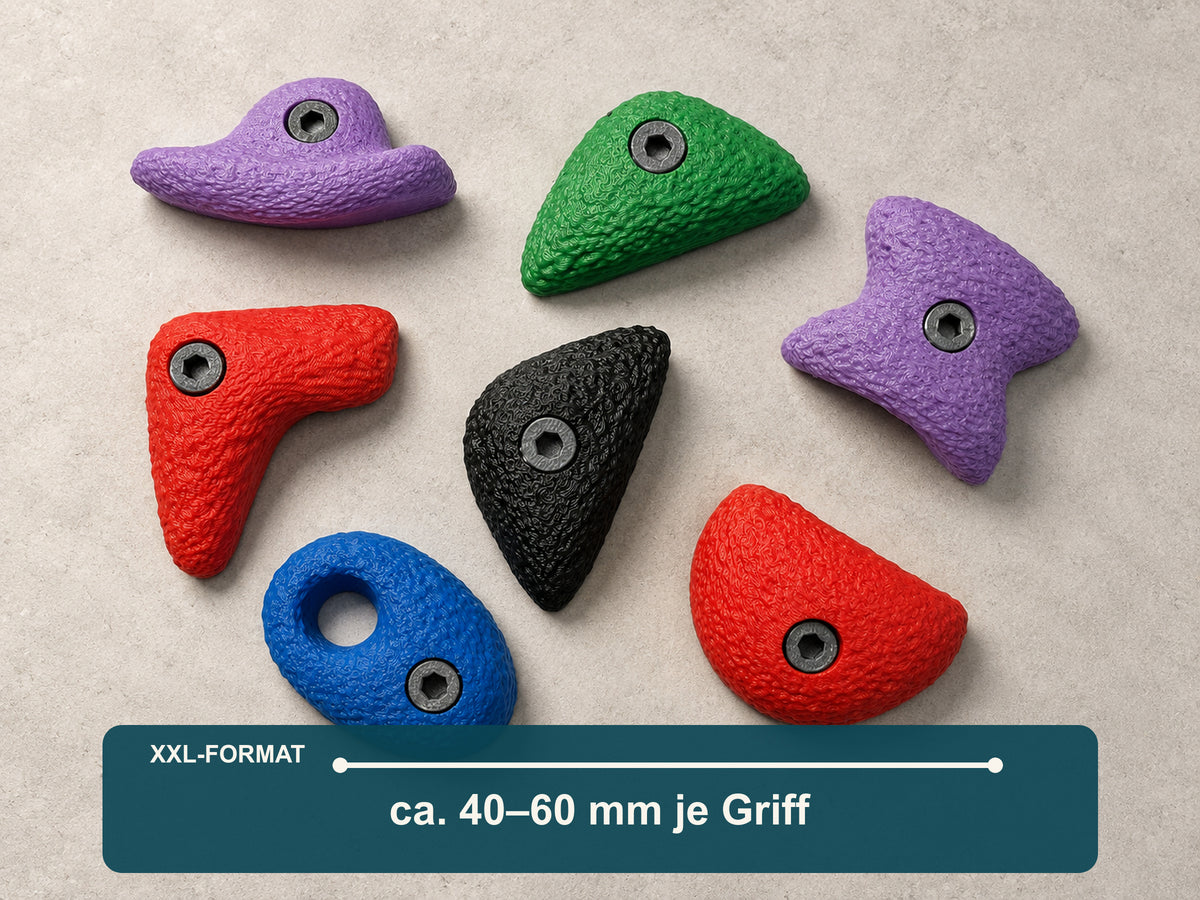 Sieben große Bouldergriff-Magnete im Farbmix auf hellem Stein mit Maßangabe: etwa 40 bis 60 Millimeter je Griff.